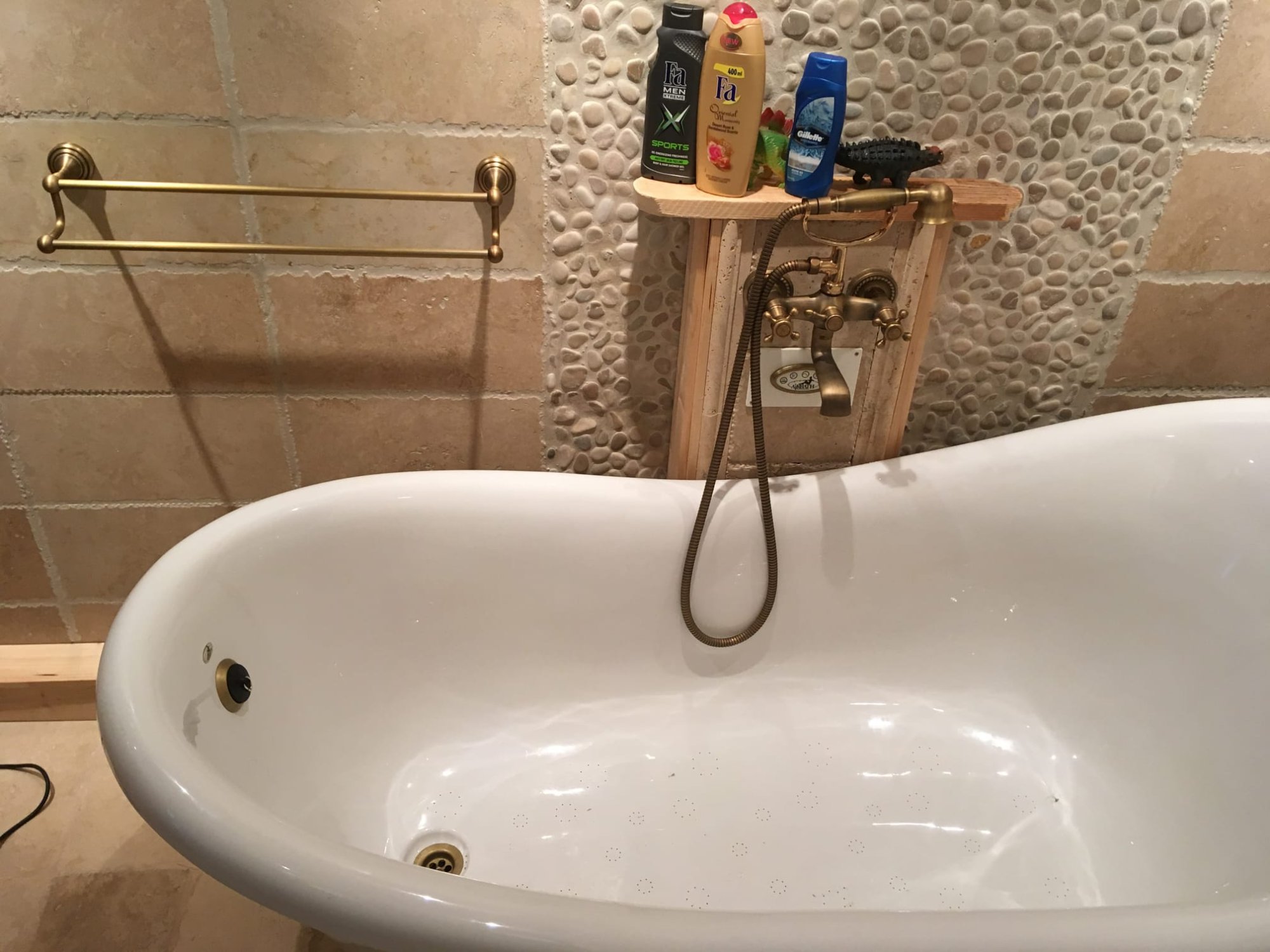 Beautifully restored freestanding bath with brass fixtures in real home setting